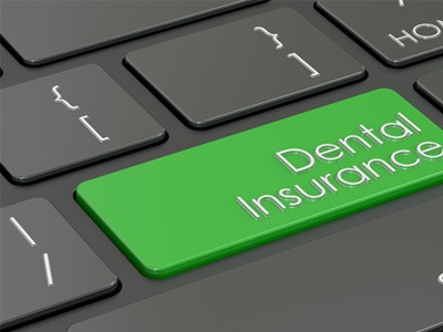 Green dental insurance key on computer keyboard