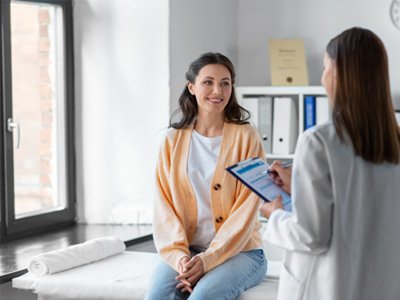 Doctor taking notes during patient’s consultation