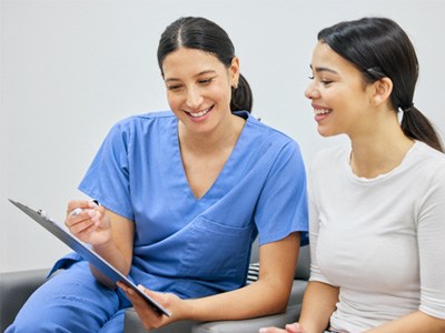 Dental team member discussing paperwork with patient