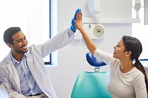 Dental patient high-fiving her dentist