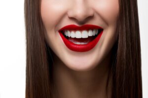 Woman’s smile with white teeth and red lipstick