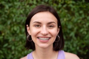 Smiling young woman with braces